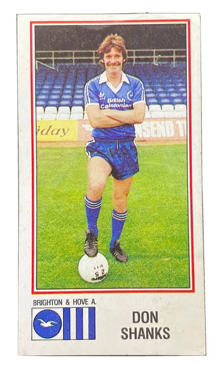 Original trading card of Don Shanks in a Brighton and Hove Albion blue shirt, one foot resting on a football