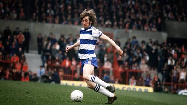 Don Shanks in blue and white hoops playing the ball during a match